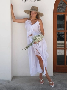 Detailed view of layered ruffles and V-neckline on a white summer chiffon crop top