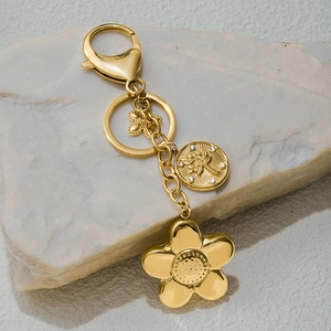 Golden stainless steel bag charm with clover, tree pendant and floral details on stone