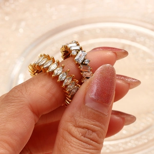 Elegant gold plated rings featuring marquise and baguette cut cubic zirconia on a hand