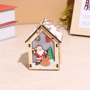 Lighted wooden Christmas house ornament with Santa and reindeer on wooden background
