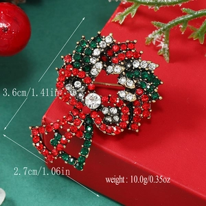 Detailed size view of Christmas wreath brooch with rhinestones measuring 3.6 by 2.7 cm