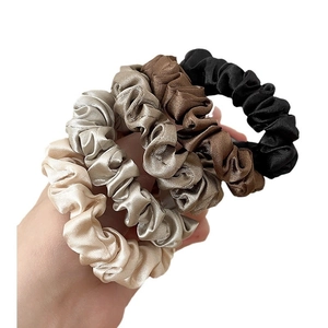Set of four satin silk scrunchies in gold, grey, brown, and black with a premium glossy finish