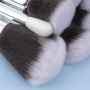 Macro detail of gradient dual-tone bristles and silver metal ferrules on makeup brushes