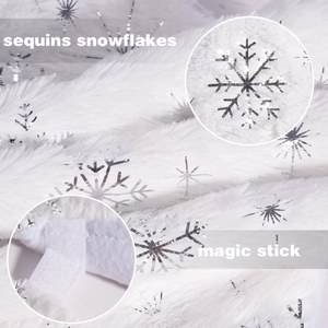 Detail of white plush Christmas tree skirt with silver sequin snowflakes and magic stick