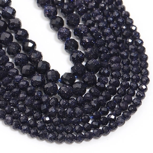 Macro detail of faceted blue sandstone beads with shimmering star-like inclusions for DIY jewelry