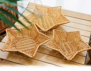 Detailed view of three handcrafted star-shaped woven fruit trays in various sizes