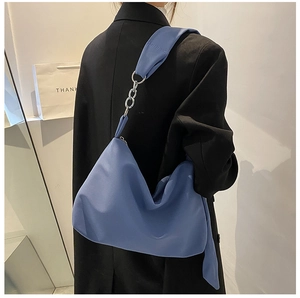 Close-up of navy blue nylon hobo bag featuring stylish silver chain strap link detail