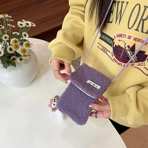 Detail of purple plush crossbody phone bag with lamb wool texture and foldover flap