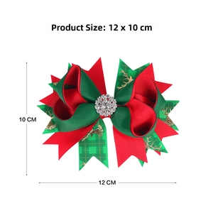 Detail showing 12x10cm red and green Christmas bow hair clip with gold reindeer and rhinestone