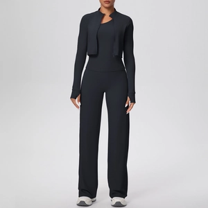 Detail of a black three-piece yoga set including zip jacket, tank top, and wide-leg pants
