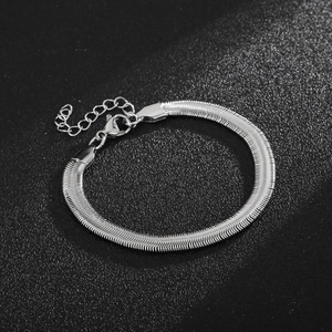 Detail view of silver snake chain bracelet with adjustable lobster clasp on black background