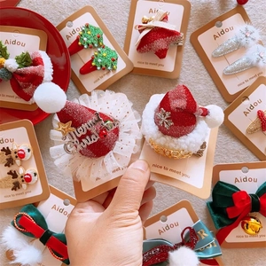 Detailed view of Christmas hair clips featuring tulle hat, sequin tree and deer