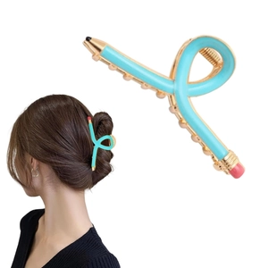 Detail of blue pencil-shaped metal hair claw showing back-of-head styling on model