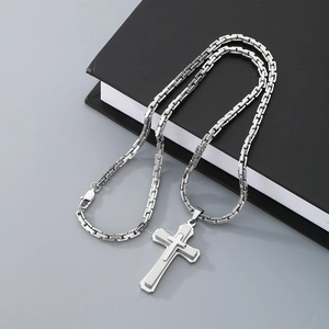 Hip hop silver multi-layer cross pendant necklace with box chain on black notebook