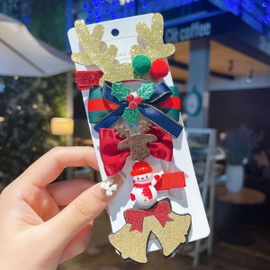 Detailed view of a 5-piece Christmas hair clip set featuring glitter reindeer and bows