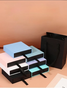 Colorful drawer jewelry display boxes with silk pulls and a matching black gift bag