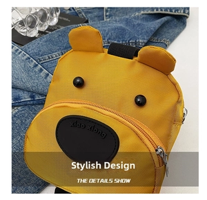 Detailed close-up of yellow bear bag with cute ears, textured fabric, and metal zipper