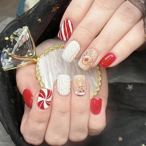 Detailed view of Christmas press-on nails featuring gingerbread man and reindeer motifs