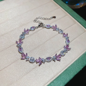 Detailed close-up of butterfly bracelet with pink stones and adjustable lobster clasp