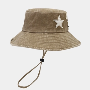 Detail of vintage washed cotton bucket hat featuring white star patch and chin strap