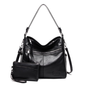 Detailed view of 2-piece black tote set featuring vintage PU leather and functional zippers