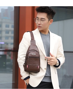 Close-up of brown PU leather men's chest bag with striped detail and zipper pockets