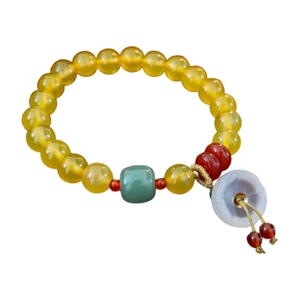 Beaded jade flower bracelet with yellow translucent beads and green barrel charm