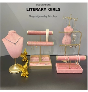 Pink velvet jewelry display set with gold metal frames for necklaces and bracelets
