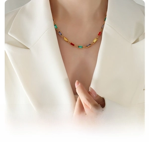 Detail of 18k gold plated titanium necklace with colorful zircon gemstones on model