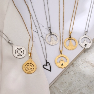 Macro shot of stainless steel lotus and Buddhist pendants in gold, silver and black