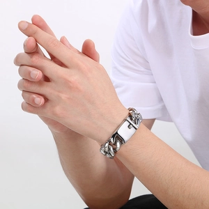 Chunky stainless steel Cuban link bracelet for men with polished finish on model wrist