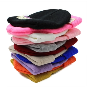 Close-up of assorted ribbed knit beanies showing thick texture and diverse color options