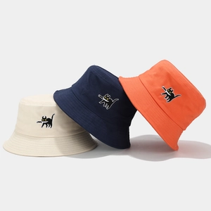 Stack of cotton bucket hats with cat embroidery in beige, navy blue, and bright orange