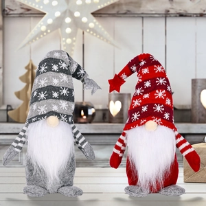 Christmas faceless gnomes with snowflake knitted hats and stars in a cozy festive setting