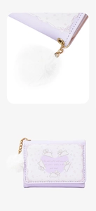 Detail of purple trifold wallet showing cute rabbit print and white pompom charm