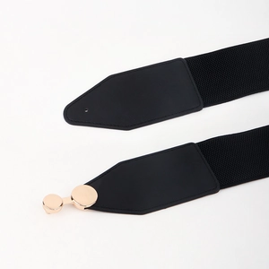 Close-up of black elastic waist belt with gold round buckle and premium PU leather finish