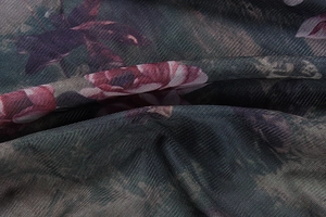 Close-up of semi-transparent floral mesh fabric with dark red and purple patterns