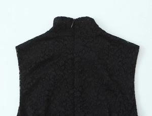 Detail of high neck lace dress featuring a back invisible zipper and intricate mesh texture