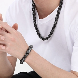 Close-up of hammered vintage titanium steel bracelet and square necklace set for men
