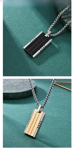 Detail of square titanium steel pendants in silver-black and silver-gold finishes