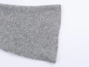 Close-up of thick grey wool knit texture showing soft felted material and fiber details