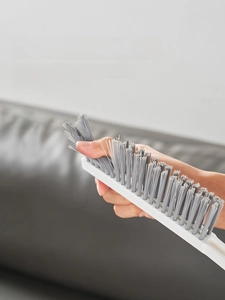Close-up of fine grey nylon bristles on a long handle radiator gap cleaning brush