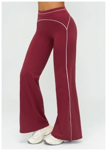 Close-up of wine red flared yoga pants with high waist and white contrast stitching detail