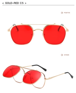 Detail view of gold metal flip-up sunglasses with red lenses and dual frame design