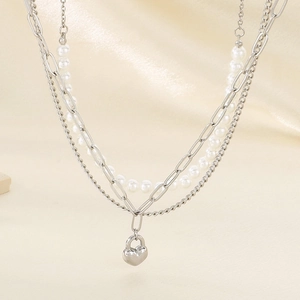 Three-layer stainless steel necklace featuring pearls and a silver heart lock pendant