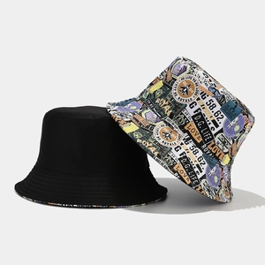 Reversible bucket hat with graffiti print and solid black minimalist cotton design