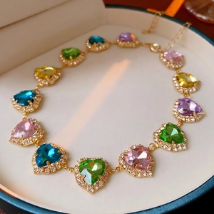 Luxury gold necklace with colorful heart-shaped gemstones and sparkling cubic zirconia