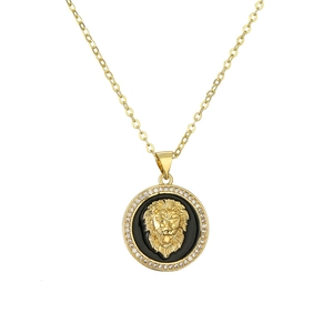 Gold lion head pendant necklace with black enamel and crystals on white background