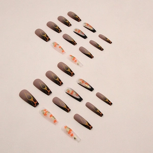 Long coffin fake nails with autumn maple leaf and orange flame designs on matte brown base