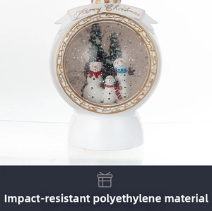 Detail of white Christmas snow globe with snowmen and Merry Christmas text decor